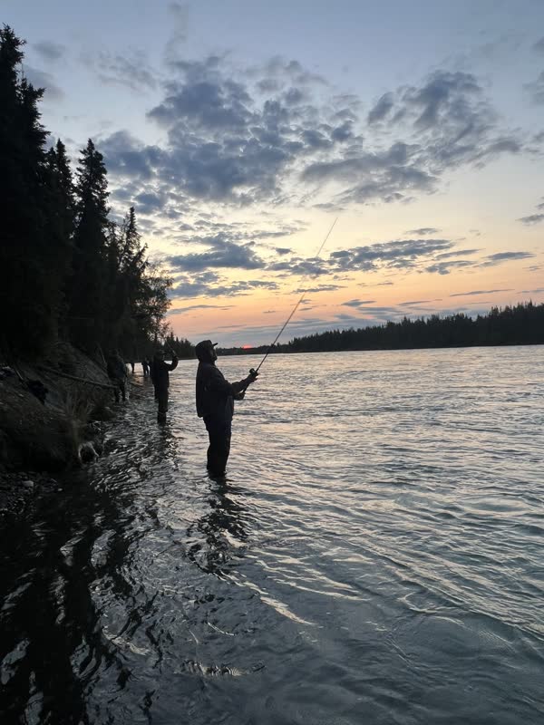 Angler casting on the Kenai River at sunset
