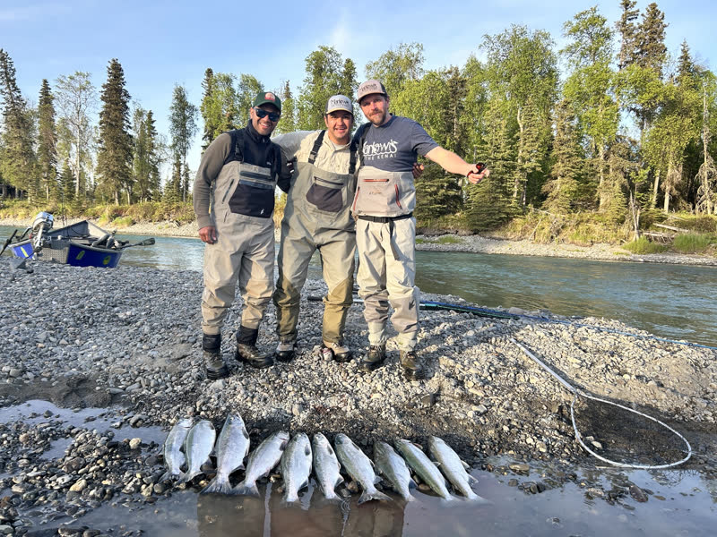 Three anglers with a limit of salmon on the Kenai