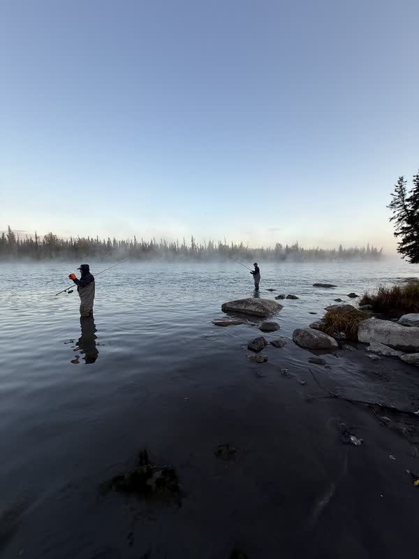Anglers wading the Kenai River at misty dawn
